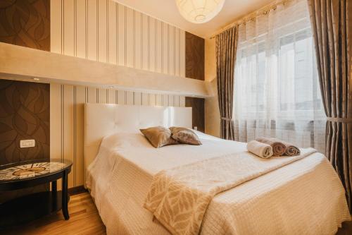 a bedroom with a bed with two towels on it at Apartment KIM in Umag