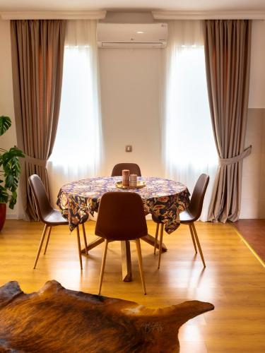 a dining room with a table and chairs at Classy & Central Apartment David (parking included) in Virpazar