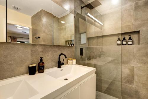 a bathroom with a sink and a shower at Designer Home w Pool & Firepit - 7 min to Brickell in Miami