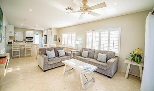 a living room with two couches and a table at Seven Mile Beach Resort in George Town