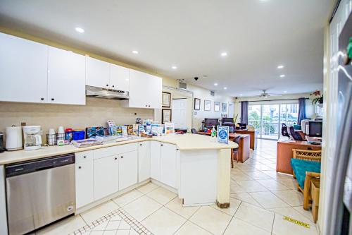 a kitchen with white cabinets and a counter top at Seven Mile Beach Resort in George Town