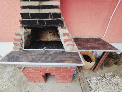 a brick oven with two shelves on top of it at BANJANSKI RAJ in Arandjelovac