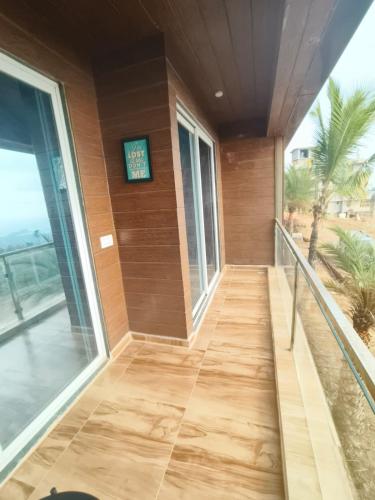 a hallway of a building with a clock on the wall at Dhayra's Seascape homestay at Dapoli in Ānjarle