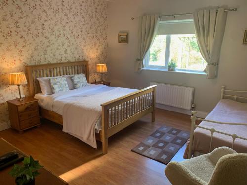 a bedroom with a bed and a window at Dungimmon House in Ballyconnell