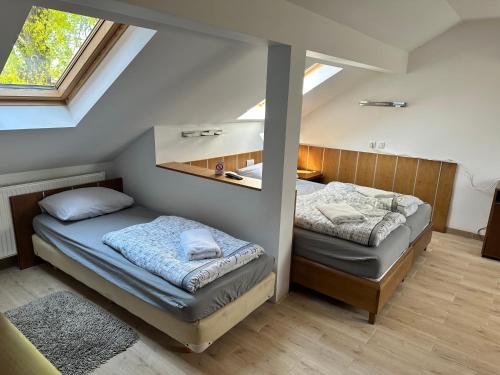 a bedroom with two beds and a mirror at Aqua terme Palic in Palić