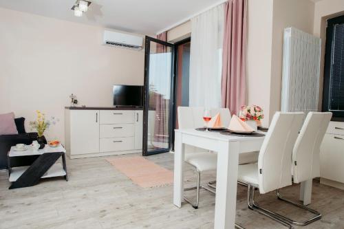 a living room with a white table and chairs at Rose Valley apartment in Kazanlŭk