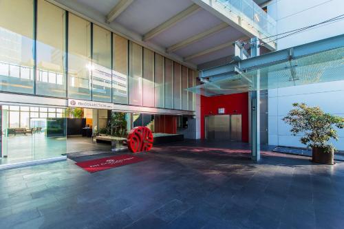a lobby of a building with a red wheel in it at NH Collection Mexico City Santa Fe in Mexico City
