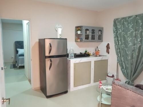 a kitchen with a stainless steel refrigerator in a room at Villa rozenuda in Boca Chica