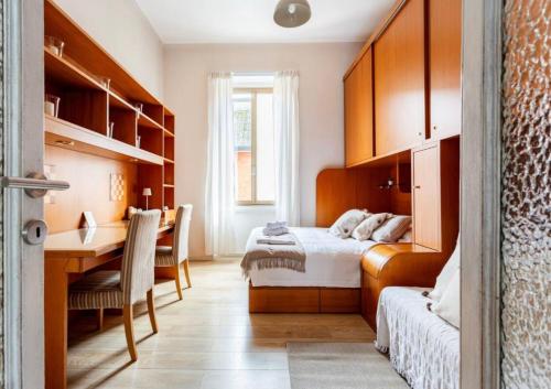 a bedroom with two beds and a desk and a table at Chiarilù near the center Politecnico Fair and City Life in Milan