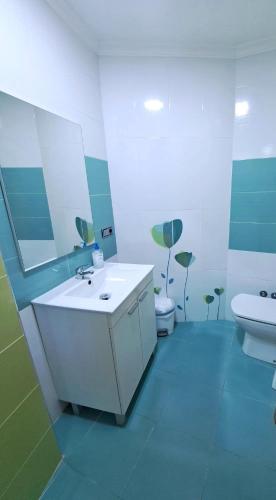 a bathroom with a sink and a toilet and a mirror at Apartamento Lola 1 in Nerja