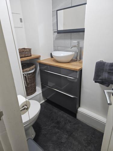 a bathroom with a sink and a toilet at Close to amenities in Weston-super-Mare