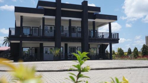 a black and white house with a balcony at Royal View Residence in Meerzorg