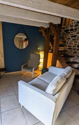 a bed in a room with a mirror and a chair at La maison du 146 in Flavin