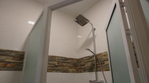 a bathroom with a shower with a glass door at Royal View Residence in Meerzorg
