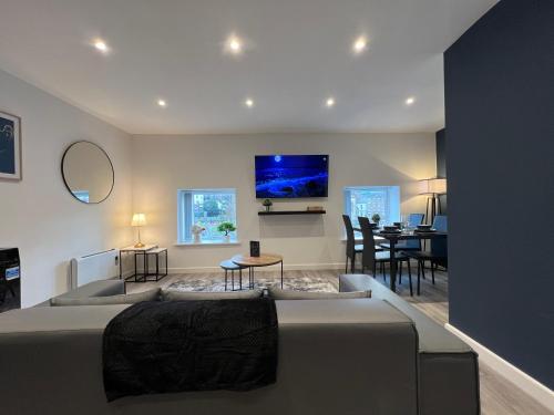 a living room with a bed and a dining room at The Seven Suites Liverpool in Liverpool