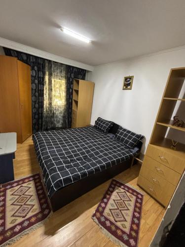ein Schlafzimmer mit einem Bett und zwei Teppichen in der Unterkunft Hypnotic Suite Pitesti in Piteşti