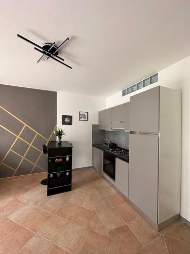 a kitchen with a refrigerator and a ceiling fan at La balena bianca house in Bagni San Filippo
