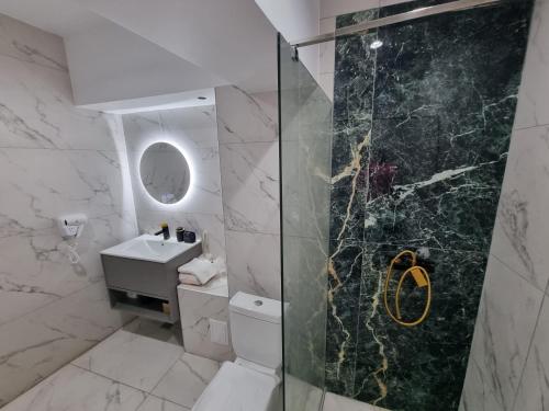 a bathroom with a shower and a toilet and a sink at Donau Resort in Eşelniţa