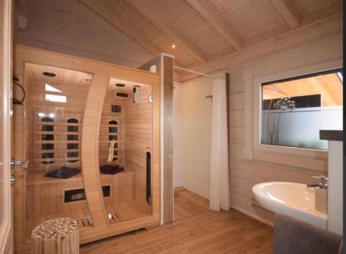 a bathroom with a shower and a sink at Blockhaus Edelweiss in Rieden