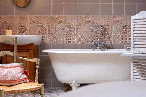 une salle de bain avec une baignoire et un lavabo dans l'établissement Le Clos Souvigny Centre ,15 min Parc Fédéral Lamotte CAUTION OBLIGATOIRE SWIKLY, à Souvigny-en-Sologne