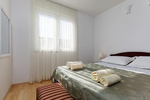 a bedroom with a large bed with towels on it at Fantasy apartment in Bol