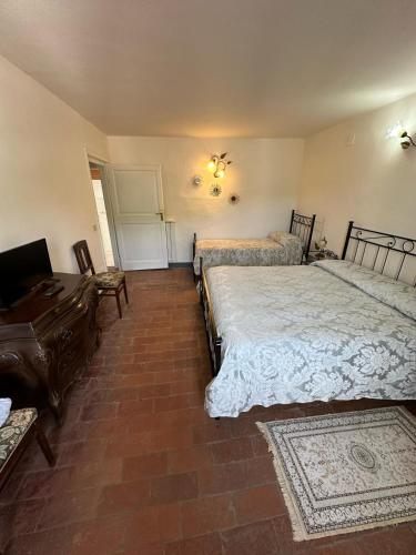 a bedroom with two beds and a desk and a piano at Casa Garibaldi in Pontremoli