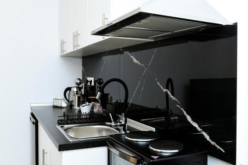 a kitchen with a sink and a stove at Sias Apartment in Alexandroupoli