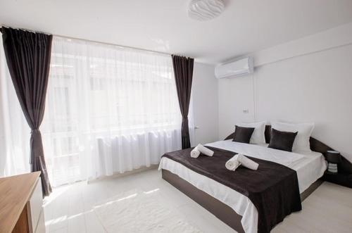 a bedroom with a bed with two towels on it at WhiteBoxApartment in Kyustendil