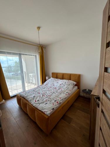 a bed in a room with a large window at Boszkowo Horizon Park in Boszkowo-Letnisko
