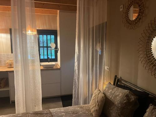 a bedroom with a bed and a sink and a mirror at Casa Fuori in Oirschot