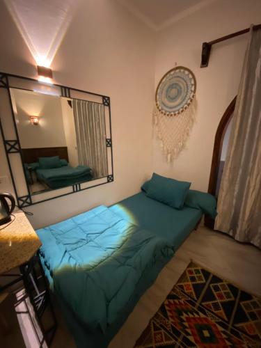 a bedroom with a bed and a mirror at light house camp in Dahab