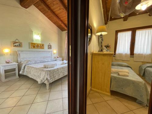 a bedroom with a large bed and a room with at L'Incanto Tanca Piras in Nebida