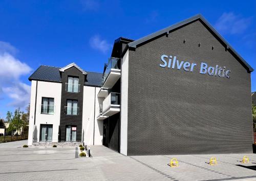 a building with a silver bottle sign on the side of it at SILVER BALTIC in Kołobrzeg