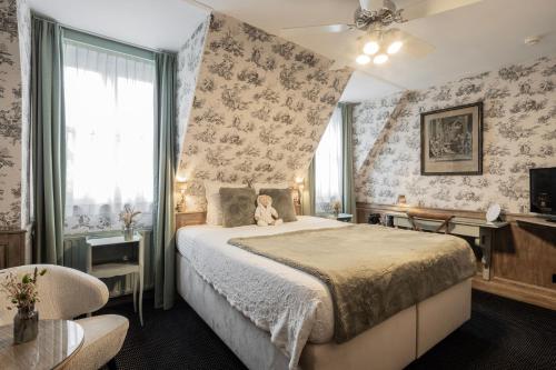 a bedroom with a bed with a teddy bear on it at Hotel Biskajer by CW Hotel Collection - Adults Only in Bruges