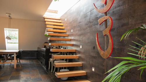 a wooden staircase in a restaurant with a sign on the wall at Penthouse in the heart of the City in Copenhagen