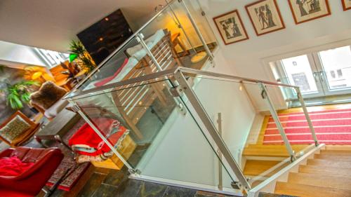 a room with a glass stair case in a house at Penthouse in the heart of the City in Copenhagen