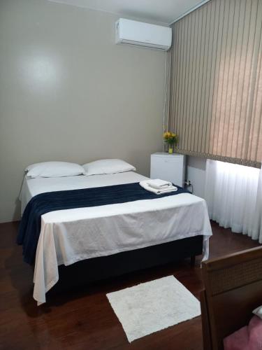 Una cama o camas en una habitación de Pousada Harmonia Pomerana
