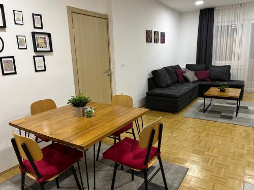 a living room with a table and a couch at For5 in Ðakovo