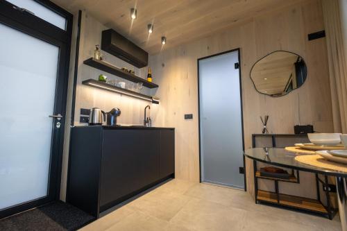 a kitchen with a table and a glass door at Ewe and Me Glamping in Northallerton