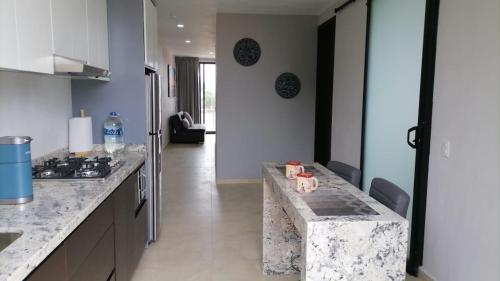 a kitchen with a marble counter top and a stove at New Modern Condo with Air-condition in Zapotlanejo