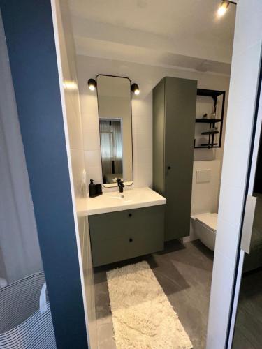 a bathroom with a sink and a mirror at Augustin. welcome home in Duće