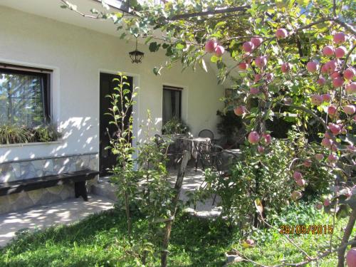 a porch of a house with a table and chairs at Rooms Pri Lovrižu in Kobarid
