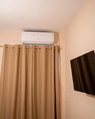 a air conditioner on top of a curtain in a room at Kostis Luxury Apartment in Agrinion