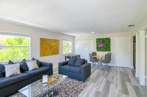 a living room with a couch and a table at Dog friendly condo with beach access, hot tub, firepit in West Palm Beach