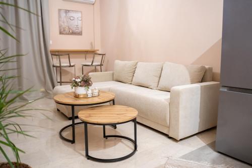 a living room with a couch and two tables at Kostis Luxury Apartment in Agrinion