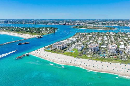 an aerial view of a beach with condos at Dog friendly condo with beach access, hot tub, firepit in West Palm Beach