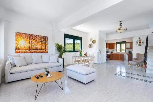 a living room with a couch and a table at Villa Giannari in Stalos