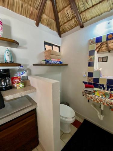 a bathroom with a toilet and a sink at Studio Candelero en Loreto in Loreto