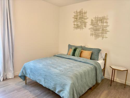 a bedroom with a bed with a blue comforter at Brand New Apt! Close to the Mall in McAllen