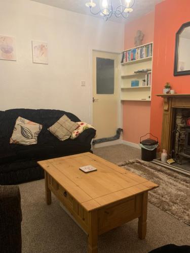 sala de estar con sofá y mesa de centro en Cobblers Cottage, en St Margaret's Hope